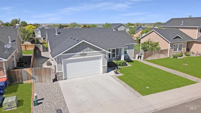 449 View Ave, Twin Falls, ID 83301 - view of front of property featuring board and batten siding, a residential view, concrete driveway, a garage, and stone siding