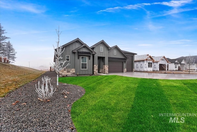 view of front of house featuring concrete driveway, stone siding, an attached garage, board and batten siding, and a front yard