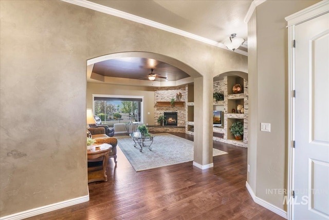 1548 Creek Stone Cir, Twin Falls, ID 83301 - living area with ceiling fan, a fireplace, arched walkways, wood finished floors, and ornamental molding