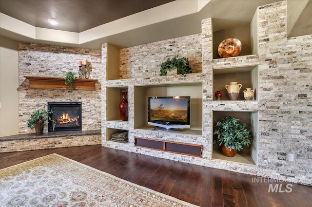 1548 Creek Stone Cir, Twin Falls, ID 83301 - living area with wood finished floors, a stone fireplace, a tray ceiling, and built in features