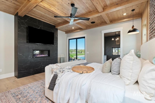 bedroom with wood ceiling, wood finished floors, and beamed ceiling
