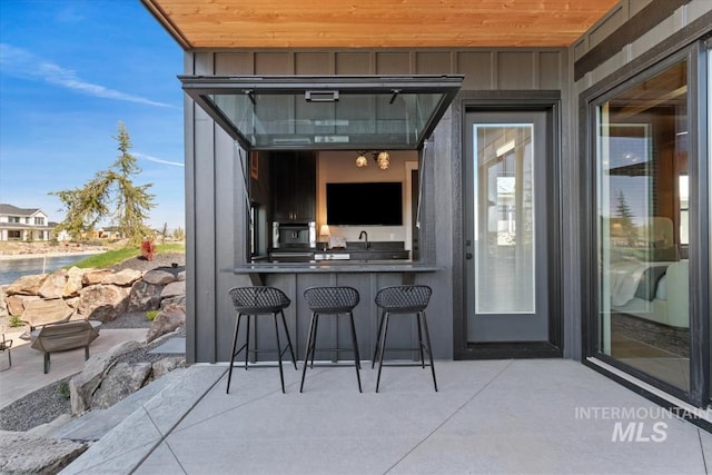 exterior space featuring a sink and a bar