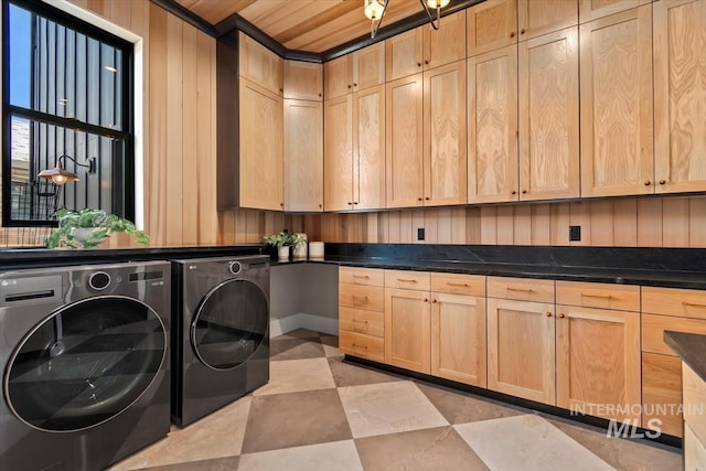 laundry area with washing machine and clothes dryer and cabinet space