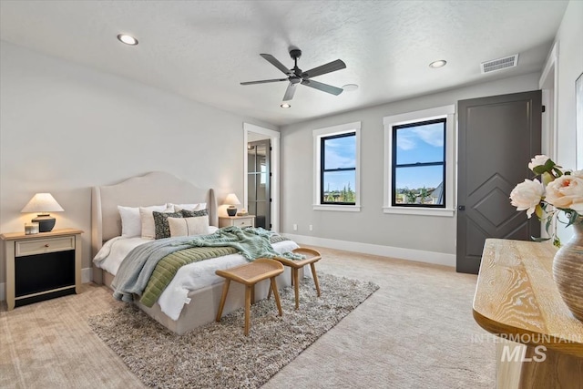 bedroom with baseboards, light carpet, visible vents, and recessed lighting