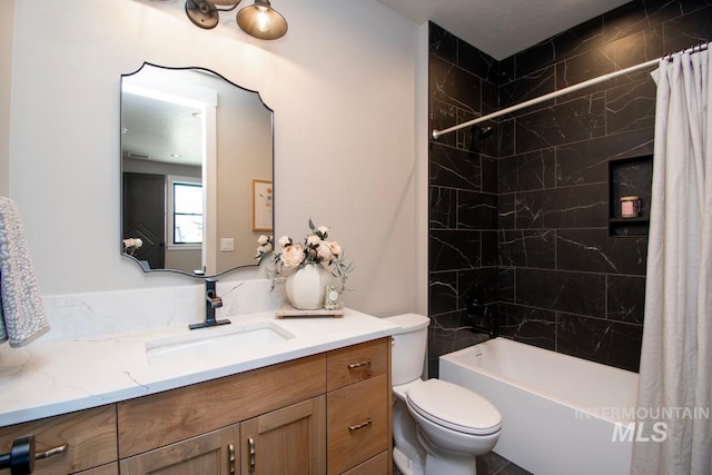 full bathroom with shower / tub combo with curtain, toilet, and vanity