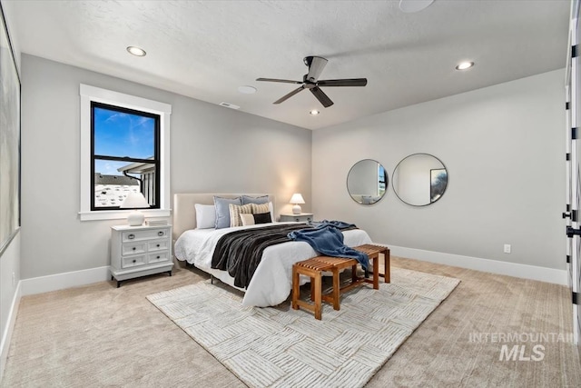 carpeted bedroom featuring baseboards, a ceiling fan, visible vents, and recessed lighting