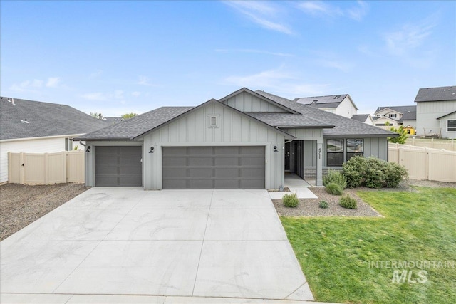 view of front of home featuring board and batten siding, a shingled roof, an attached garage, and concrete driveway