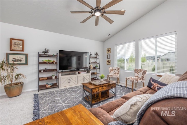 carpeted living room with ceiling fan, baseboards, and high vaulted ceiling