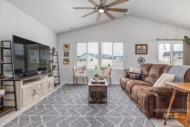 carpeted living area with vaulted ceiling, ceiling fan, and baseboards