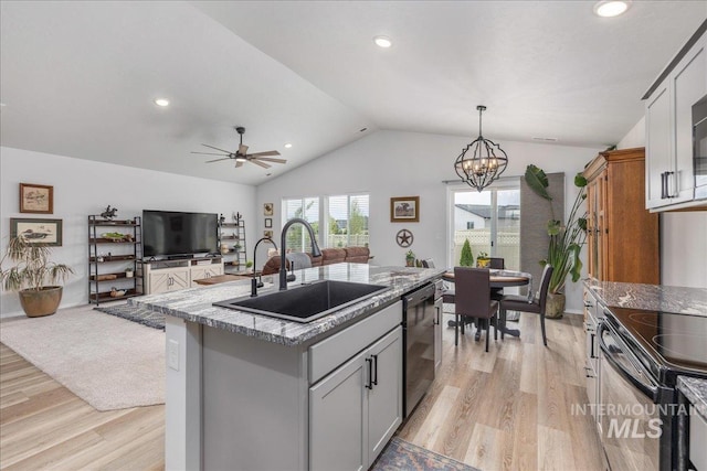 kitchen featuring a sink, dishwasher, vaulted ceiling, light wood-style flooring, and gray cabinetry