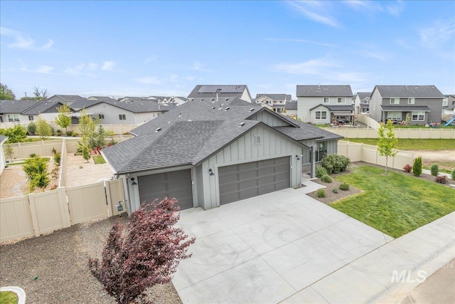 view of front of property with board and batten siding, a residential view, an attached garage, roof with shingles, and driveway