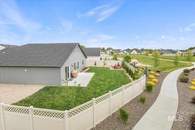 view of home's exterior featuring a residential view, a patio area, and a shingled roof