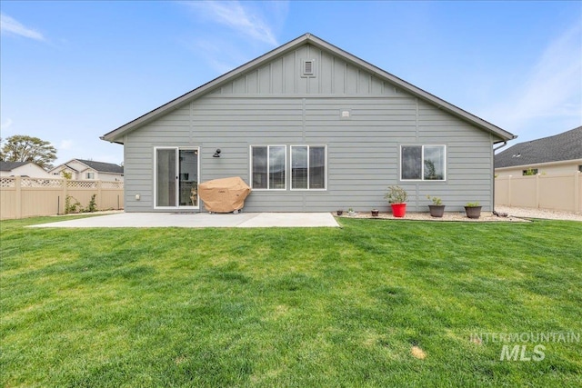 rear view of house with a patio area and board and batten siding