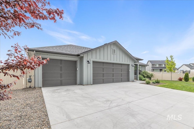 modern inspired farmhouse featuring an attached garage, board and batten siding, fence, concrete driveway, and roof with shingles