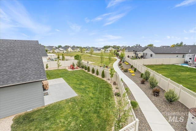 view of yard featuring a residential view and a patio area
