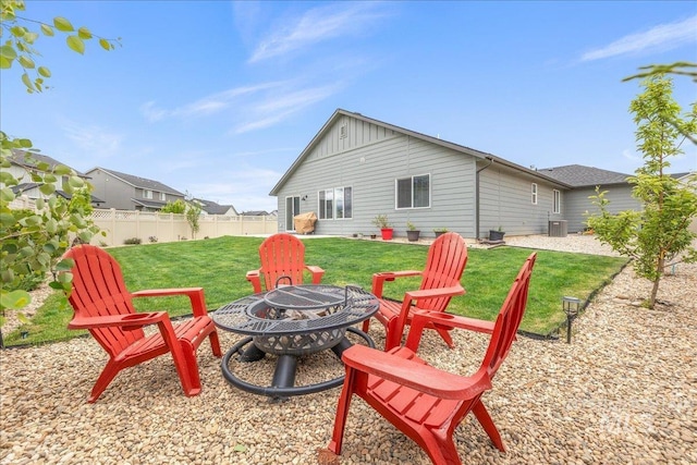 view of yard featuring an outdoor fire pit and central AC