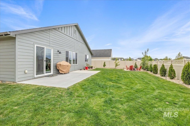 rear view of property featuring board and batten siding and a patio area