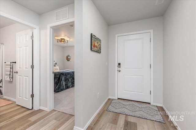 entrance foyer with wood finished floors and baseboards