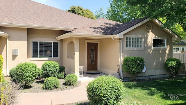 1719 E Horse Creek Ct, Meridian, ID 83642 - entrance to property with stucco siding, a shingled roof, and a yard