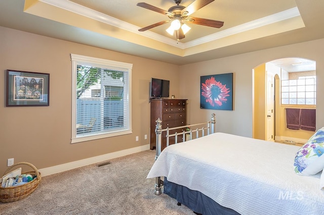 1719 E Horse Creek Ct, Meridian, ID 83642 - carpeted bedroom featuring a tray ceiling, arched walkways, crown molding, and baseboards