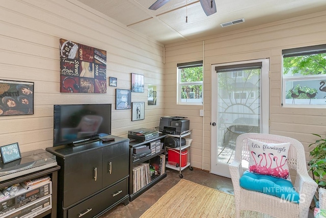 1719 E Horse Creek Ct, Meridian, ID 83642 - office area with wood walls, a ceiling fan, plenty of natural light, and concrete flooring