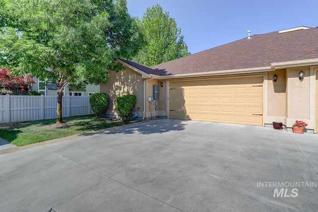 1719 E Horse Creek Ct, Meridian, ID 83642 - view of front of house with stucco siding, an attached garage, and concrete driveway
