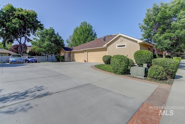 1719 E Horse Creek Ct, Meridian, ID 83642 - view of side of property with a garage, driveway, and stucco siding