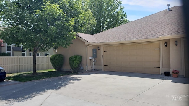 1719 E Horse Creek Ct, Meridian, ID 83642 - view of front of house featuring an attached garage, concrete driveway, stucco siding, and roof with shingles