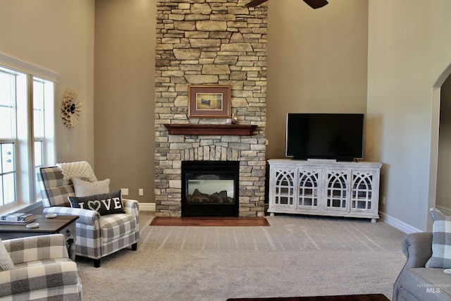 3703 E 3793 N, Kimberly, ID 83341 - living area with a high ceiling, ceiling fan, plenty of natural light, a stone fireplace, and carpet flooring
