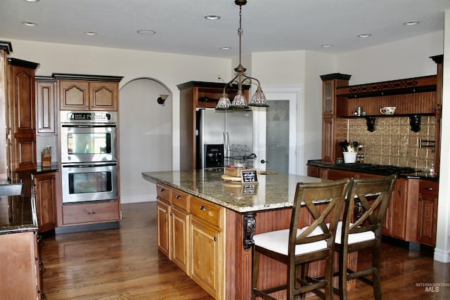 3703 E 3793 N, Kimberly, ID 83341 - kitchen with appliances with stainless steel finishes, open shelves, dark wood finished floors, tasteful backsplash, and dark stone counters