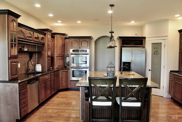 3703 E 3793 N, Kimberly, ID 83341 - kitchen featuring stainless steel appliances, a breakfast bar area, recessed lighting, light wood finished floors, and dark stone countertops