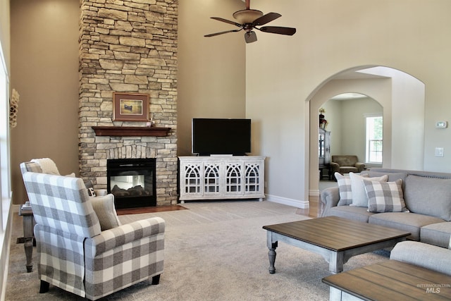 3703 E 3793 N, Kimberly, ID 83341 - living area featuring a ceiling fan, arched walkways, carpet flooring, a stone fireplace, and a towering ceiling