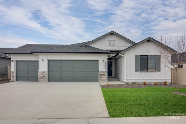 view of front facade featuring concrete driveway, an attached garage, board and batten siding, and a front lawn