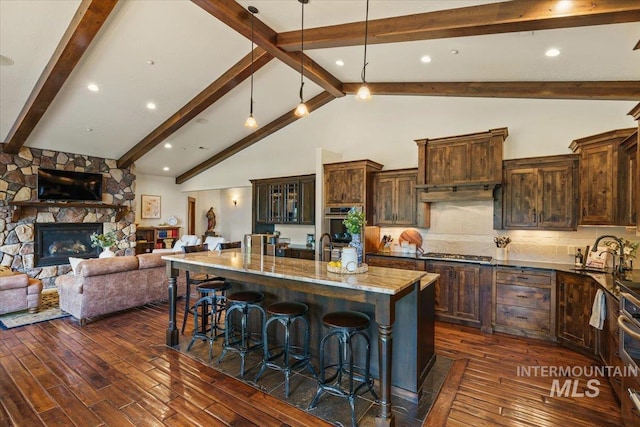 3801 S Carpenter Loop, Post Falls, ID 83854 - kitchen featuring light stone counters, a sink, dark wood-style flooring, and beamed ceiling