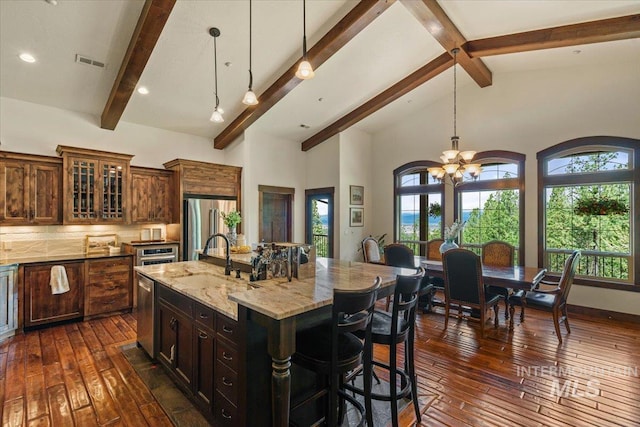 3801 S Carpenter Loop, Post Falls, ID 83854 - kitchen featuring visible vents, dark wood-style flooring, light stone counters, a sink, and stainless steel appliances