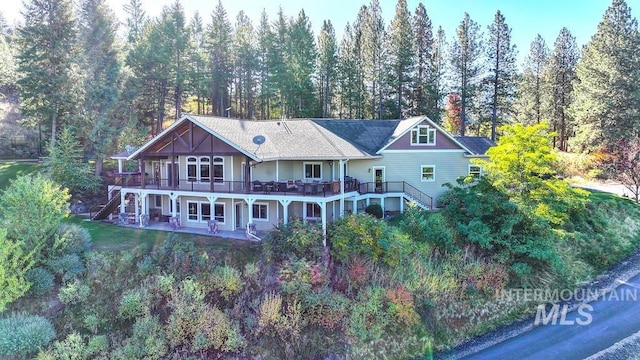 3801 S Carpenter Loop, Post Falls, ID 83854 - back of property with stairs, a patio area, a wooden deck, and a chimney