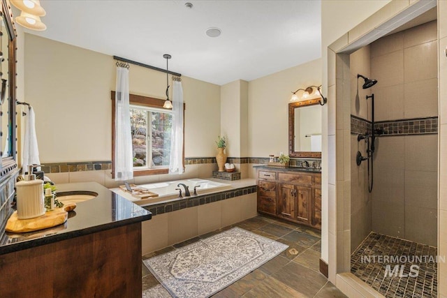 3801 S Carpenter Loop, Post Falls, ID 83854 - bathroom featuring a sink, two vanities, tiled shower, and a bath