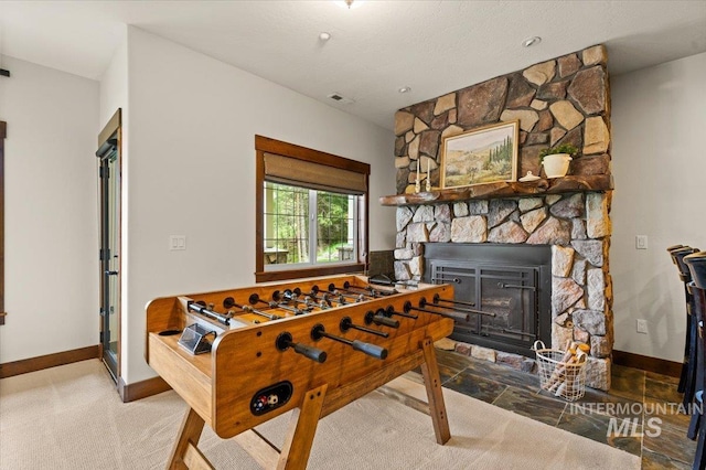 3801 S Carpenter Loop, Post Falls, ID 83854 - rec room featuring baseboards, a fireplace, and visible vents