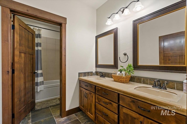 3801 S Carpenter Loop, Post Falls, ID 83854 - full bathroom with a sink, stone finish floor, baseboards, and double vanity