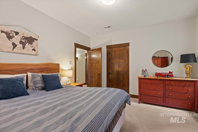 3801 S Carpenter Loop, Post Falls, ID 83854 - bedroom with visible vents, a closet, and light colored carpet