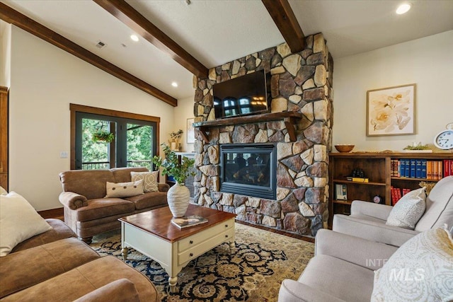 3801 S Carpenter Loop, Post Falls, ID 83854 - living area featuring a fireplace, baseboards, wood finished floors, vaulted ceiling with beams, and visible vents
