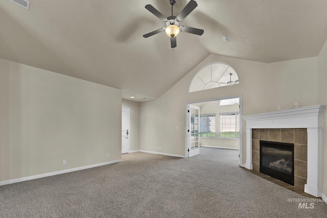 2870 N Cloverdale, Boise, ID 83713 - unfurnished living room with ceiling fan, carpet floors, a tiled fireplace, and high vaulted ceiling