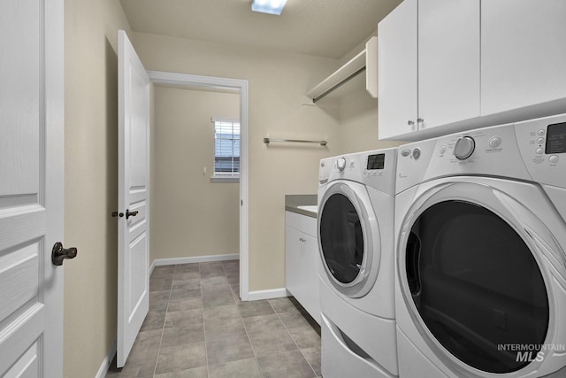 2870 N Cloverdale, Boise, ID 83713 - laundry room with washing machine and clothes dryer, cabinet space, and light tile patterned flooring