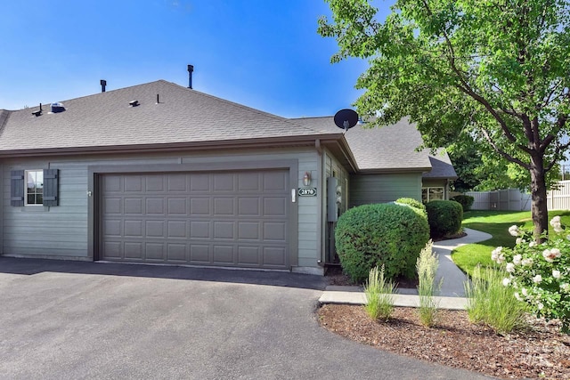 2870 N Cloverdale, Boise, ID 83713 - view of property exterior with asphalt driveway, an attached garage, and a shingled roof