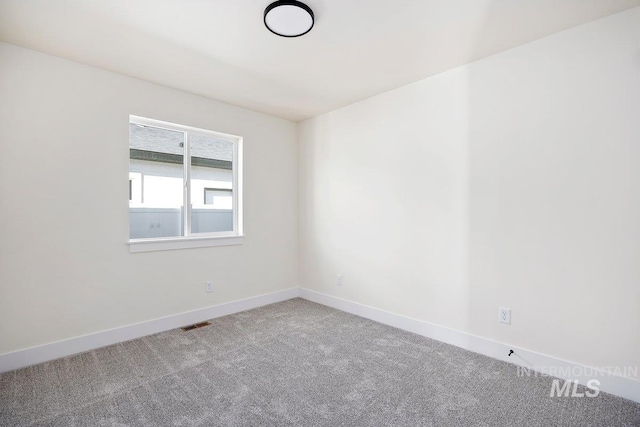 spare room featuring visible vents, baseboards, and carpet flooring