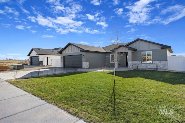 view of front of property with fence, driveway, an attached garage, stone siding, and board and batten siding