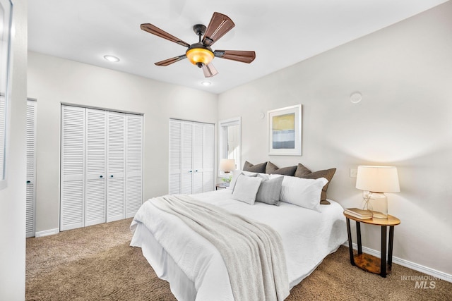 carpeted bedroom featuring recessed lighting, two closets, baseboards, and a ceiling fan