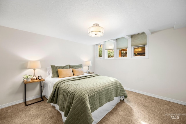 bedroom with carpet, baseboards, and a textured ceiling