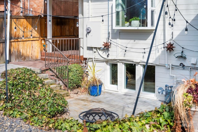 rear view of house with a patio area and fence