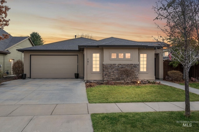 view of front facade with a yard, stucco siding, concrete driveway, fence, and a garage